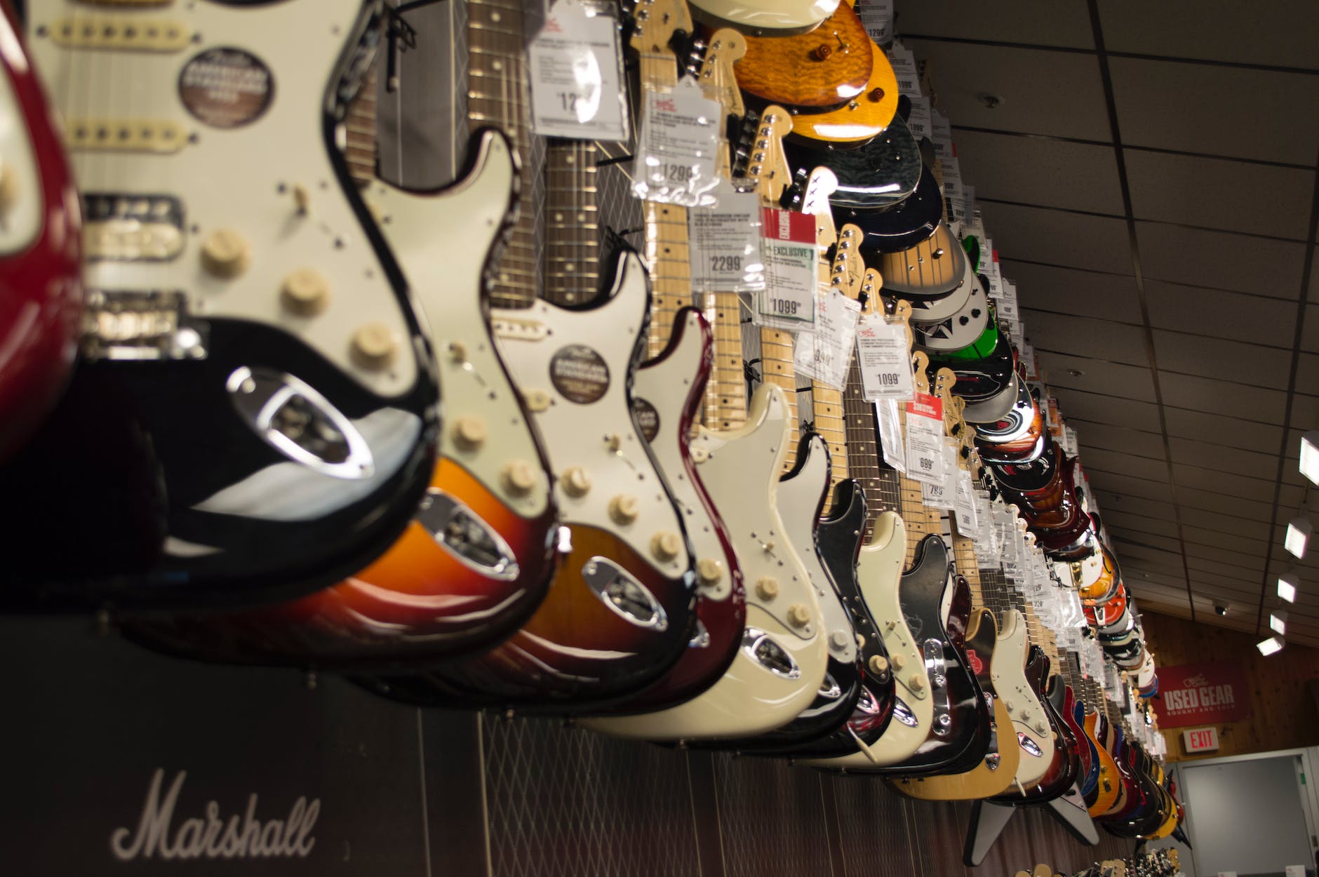 electric guitar hanging near wall